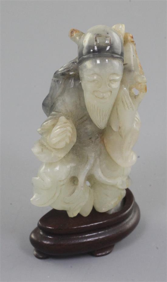 A Chinese white and black jade figure of an old man, 18th / 19th century, 7.3cm, wood stand